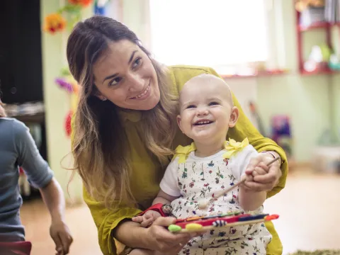 A young mom enjoys play time with her baby