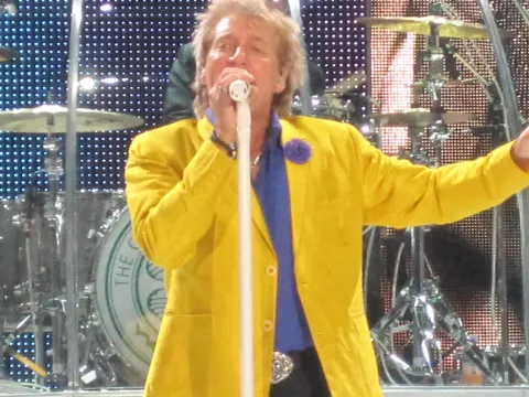 Rod Stewart performing on stage.