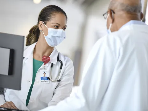 An AdventHealth team member talking with a patient.