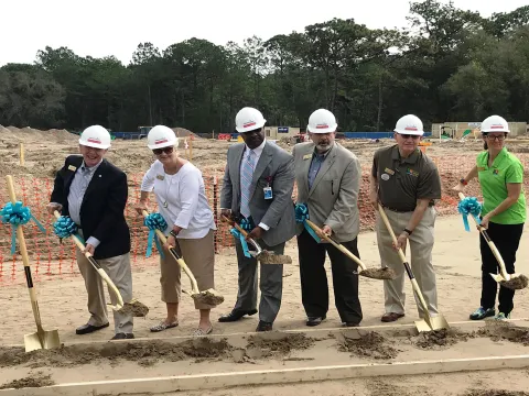 Employees celebrate groundbreaking ceremony
