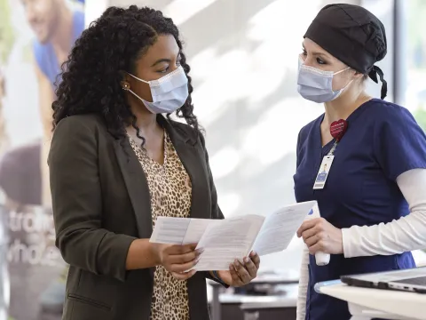 A woman talking with a doctor.