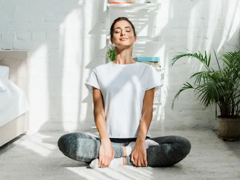 A woman taking a deep breath.