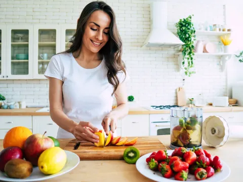 A young woman prepping food at home.