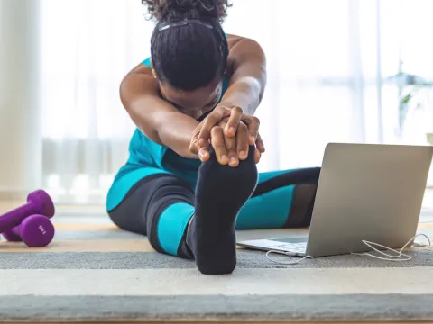 A woman stretching at home.