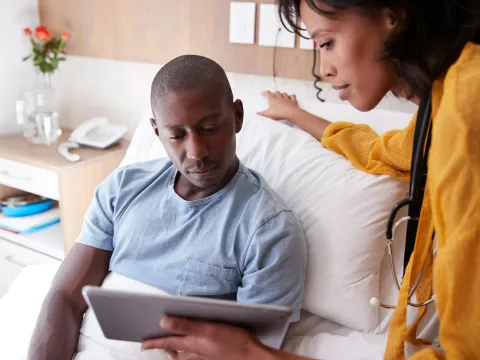 Young man discusses his care with a provider
