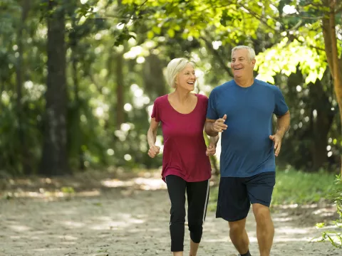 Older couple Jogging through the woods