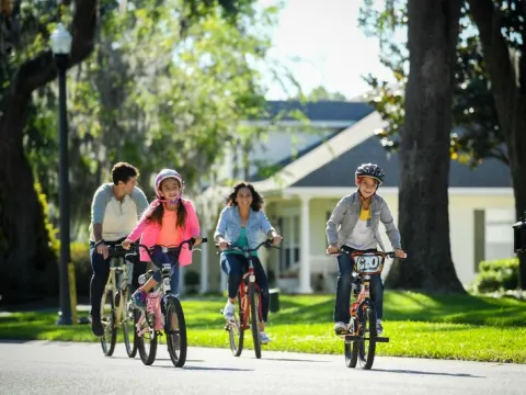 A family rides their bikes in neighborhood