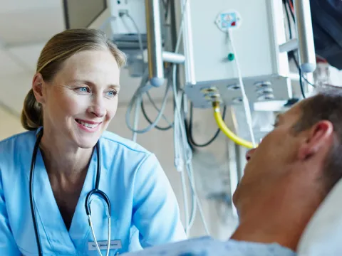 doctor-talking-to-patient and smiling