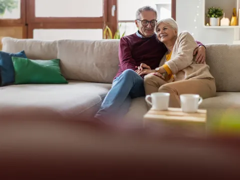 Hero older couple sitting on couch