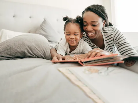 Woman Reading with daughter.