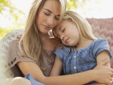 A mother comforting her daughter.