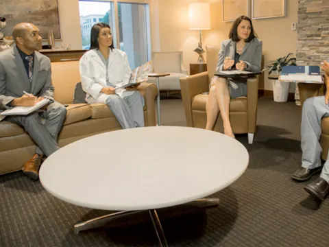 People talking in the Nicholson Center Collaboration Room.