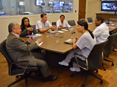 Professionals in a meeting in a Nicholson Center Lab Boardroom.