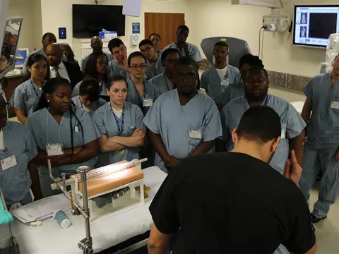 Surgeons watching a spinal surgery demonstration.