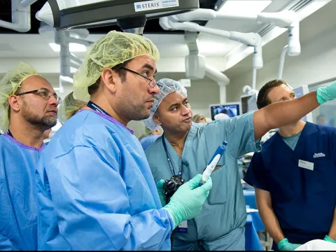 Surgeon receiving instruction in a Nicholson Center operating room.