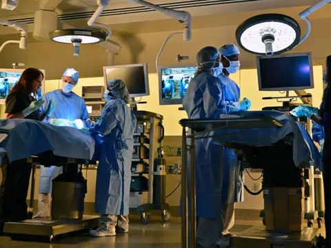 Surgeons around operating tables at the Nicholson Center.