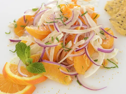 Mound of orange fennel salad with orange garnishes