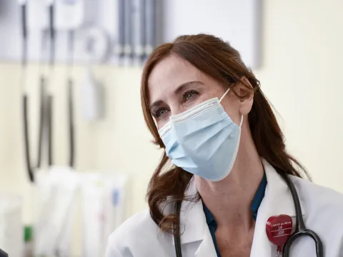 Smiling Physician wearing a mask