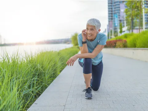 Older female runner taking a break
