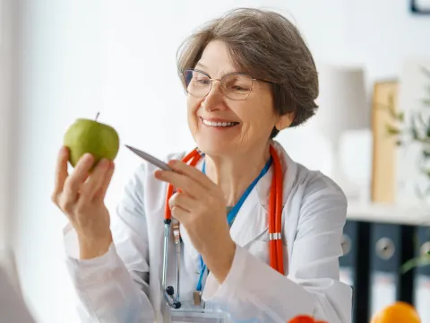 A Physician Points to an Apple with a Pen