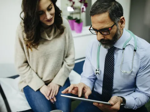 Woman discussing treatment with doctor