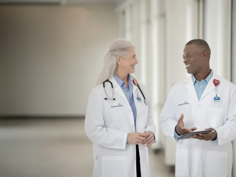 Two doctors talking in a hallway at a hospital