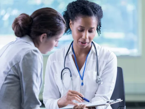 A physician talking with her patient.