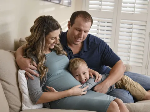 Pregnant woman with her husband and son