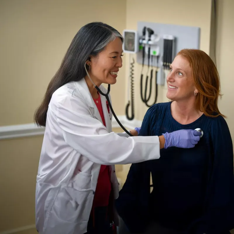 A Provider Checks Her Patient's Vitals in an Exam Room