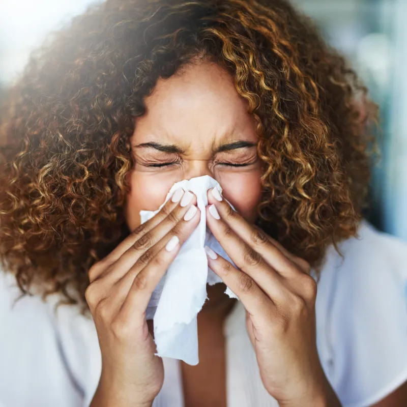 A Woman Blows Her Nose