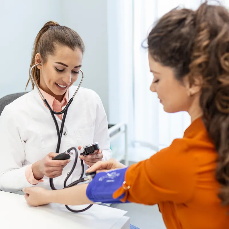 A Provider Takes Her Patient's Blood Pressure