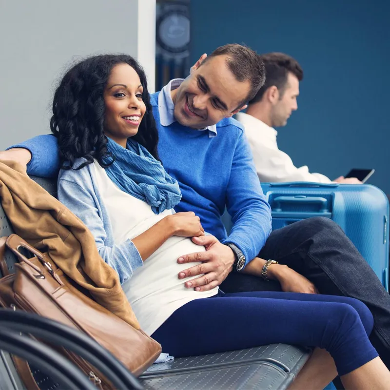 Pregnant woman with husband in airport