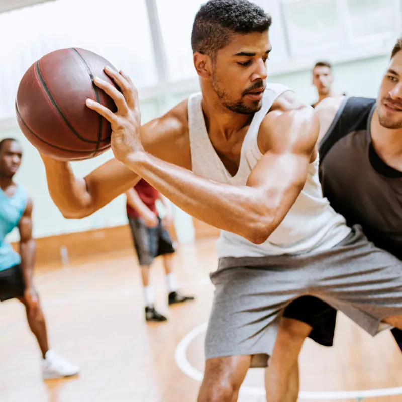 A group of young men playing basketball