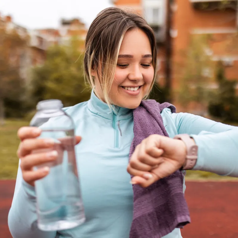 Woman Checking her time after a run