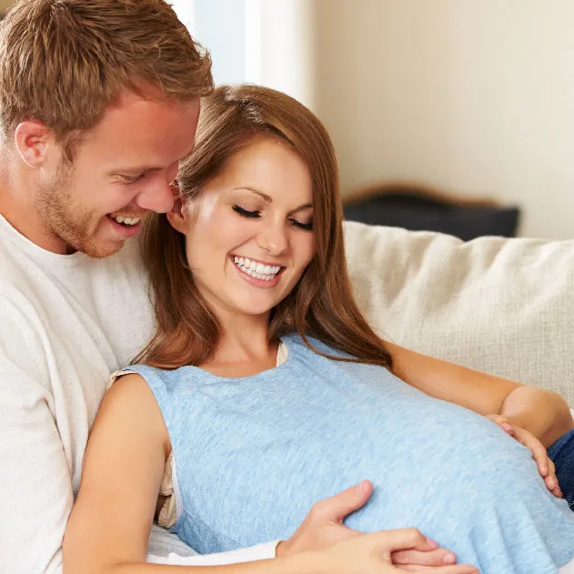A couple admiring the belly of their baby