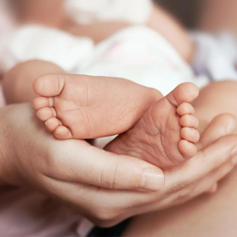 Mother holding her baby's feet