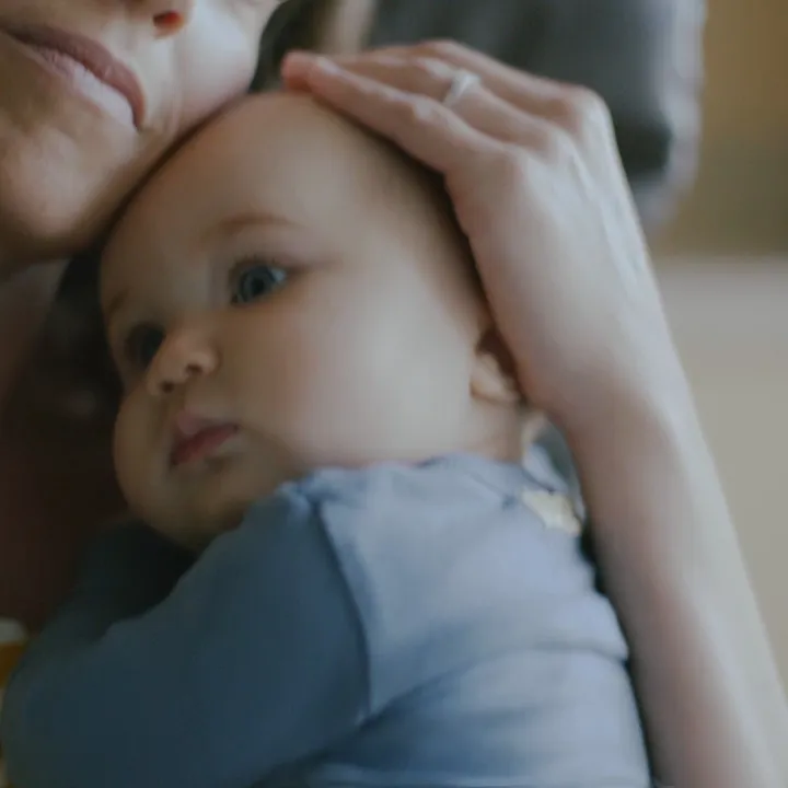 A mother holding her baby