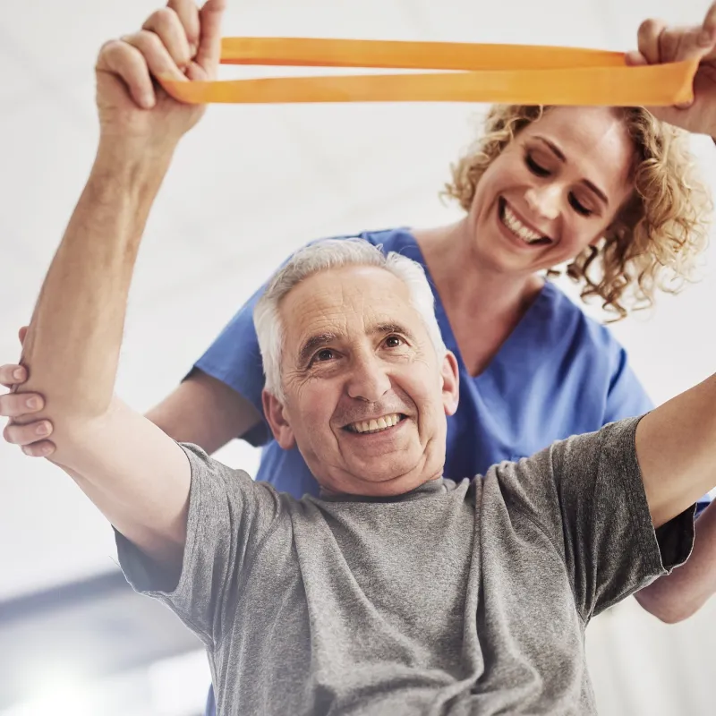 An older man receives physical therapy.