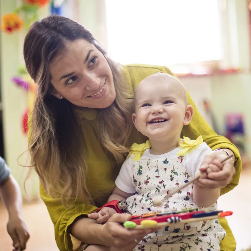 A young mom enjoys play time with her baby