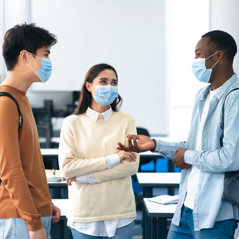 A group of students talking in their classroom