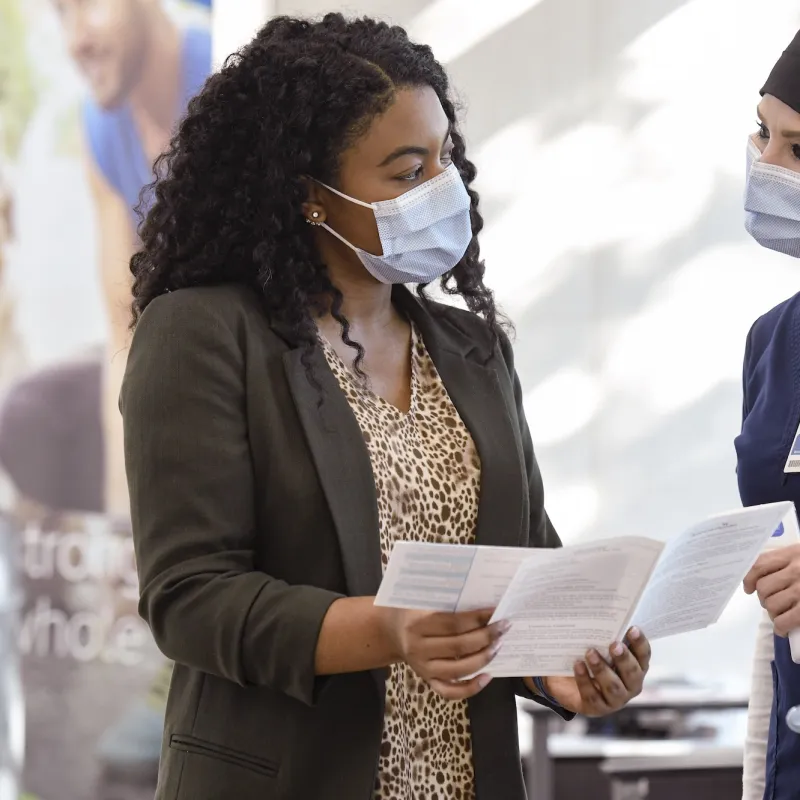 A woman talking with a doctor.