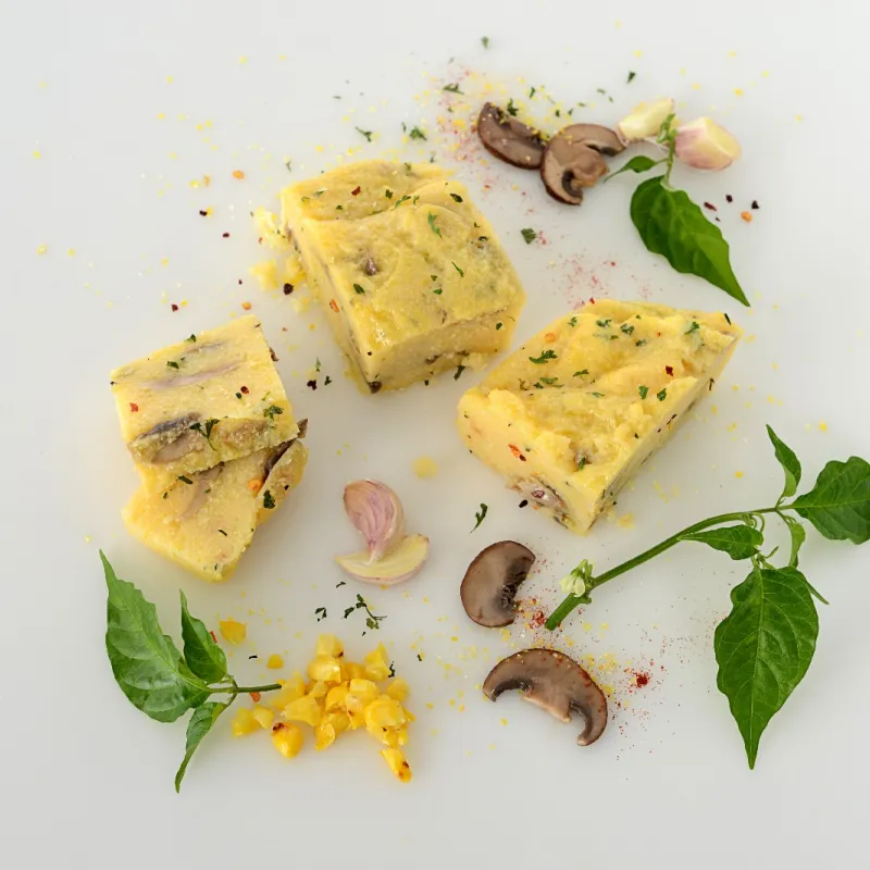 sliced squares of polenta with mushrooms and herbs