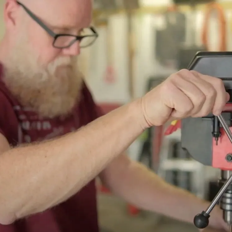 Mat Germann operating a drill press.