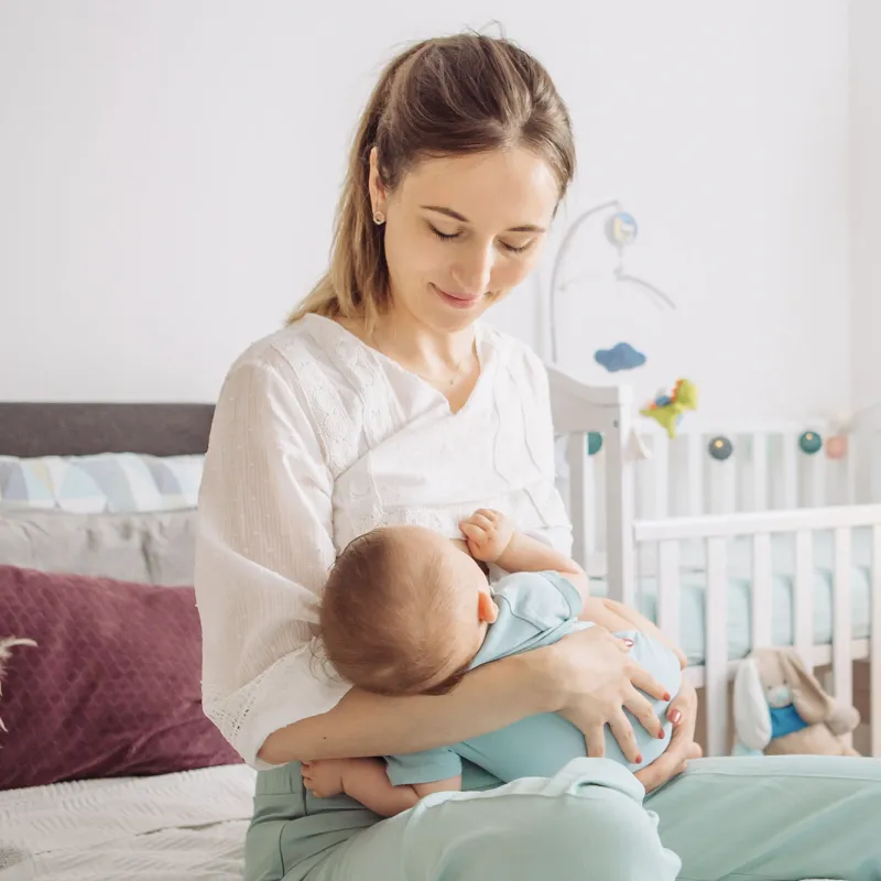 A woman breastfeeding her infant.
