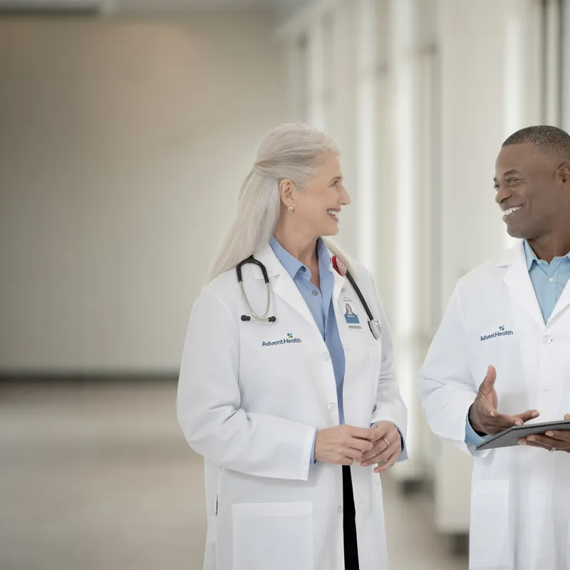 Two doctors talking in a hallway at a hospital