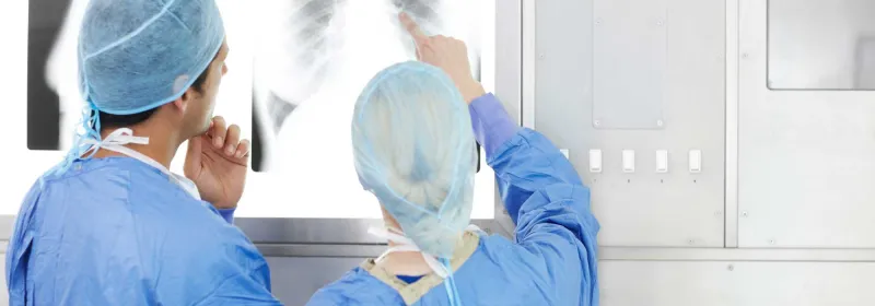 Two physicians discussing their thoughts on an x-ray
