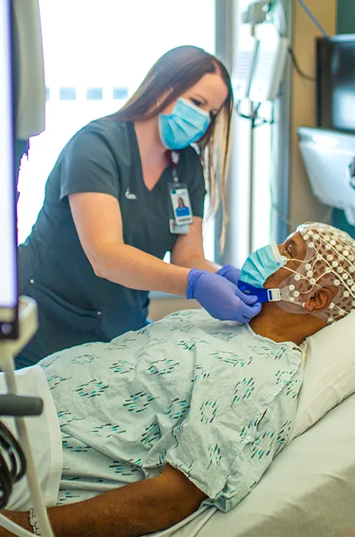 Provider attending patient before brain scan procedure